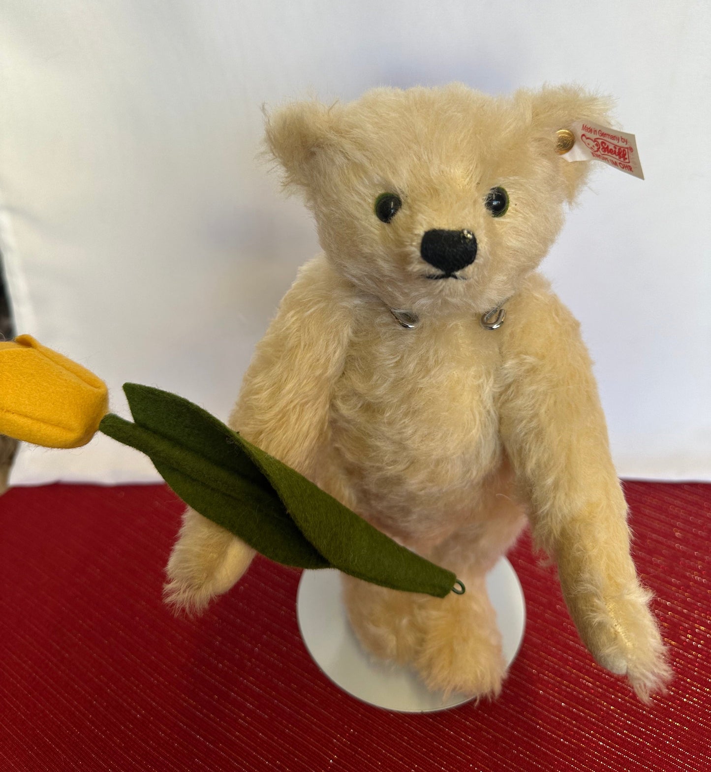 Steiff Tim Teddy Bear with Tulip tan mohair fur yellow and green flower in right hand.